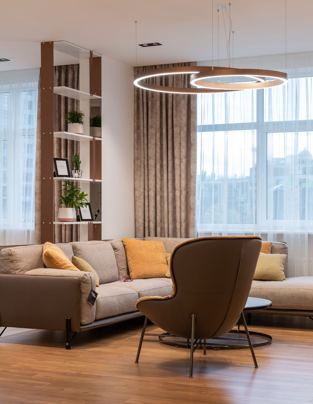 Bright living room with large windows and green plants