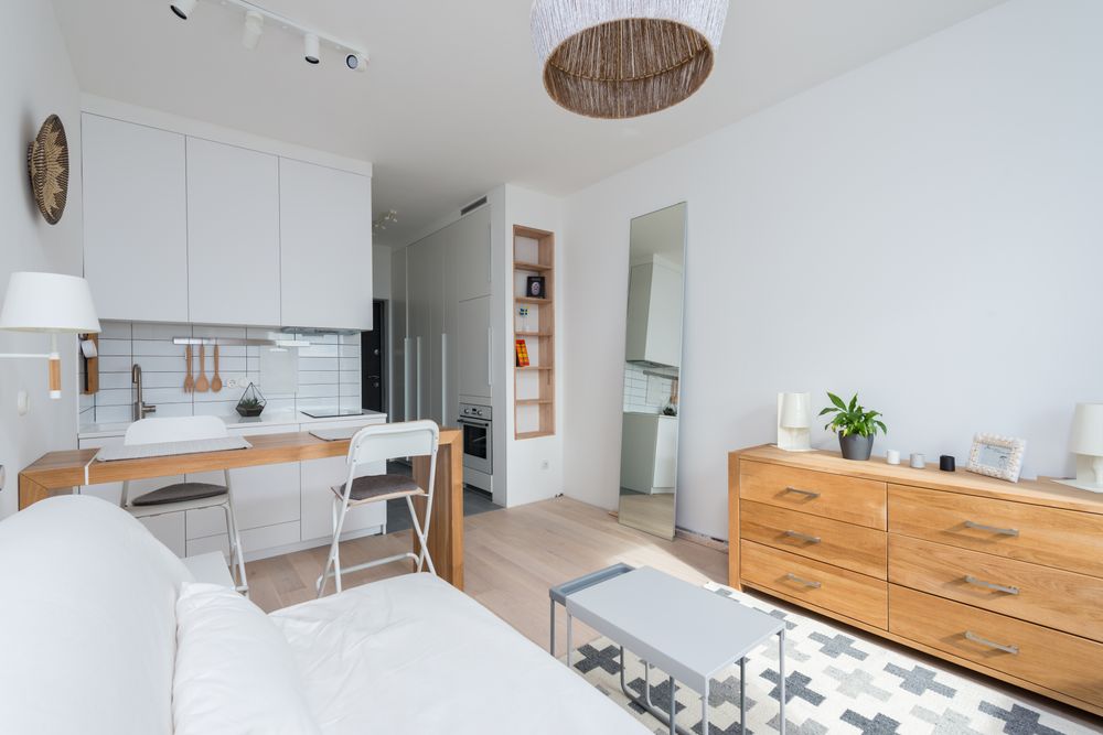Compact apartment with an open wood kitchen and light furnishings