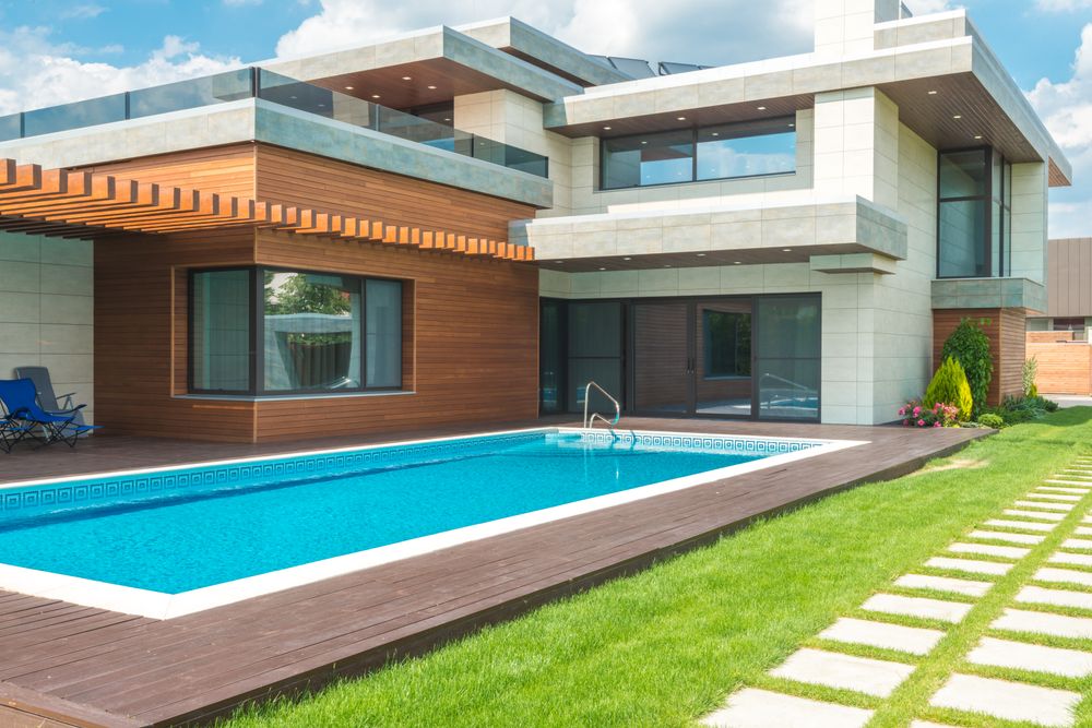 Modern home with full-height windows overlooking a swimming pool